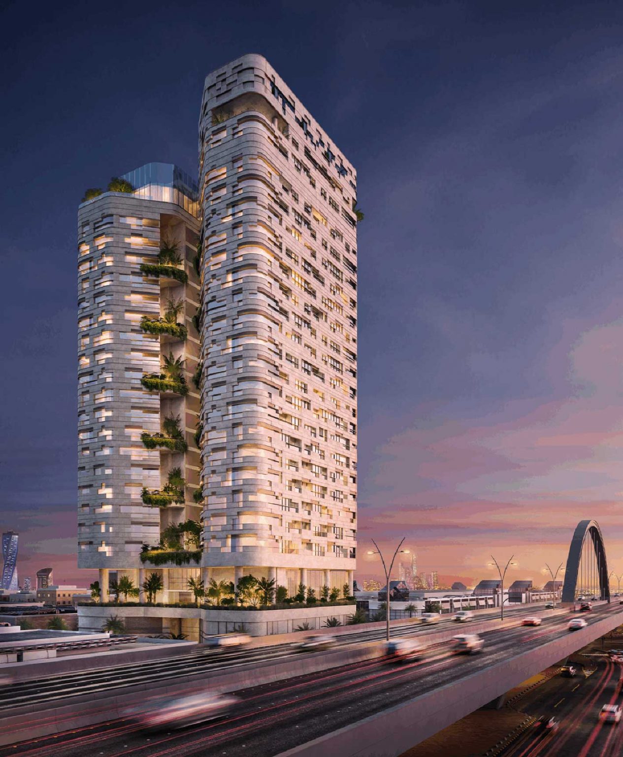 Exterior of AREIC Tower, featuring a modern high-rise building with lush greenery on balconies, adjacent to a busy bridge at sunset. The sky is a gradient of pink and purple hues, creating a tranquil yet vibrant atmosphere.