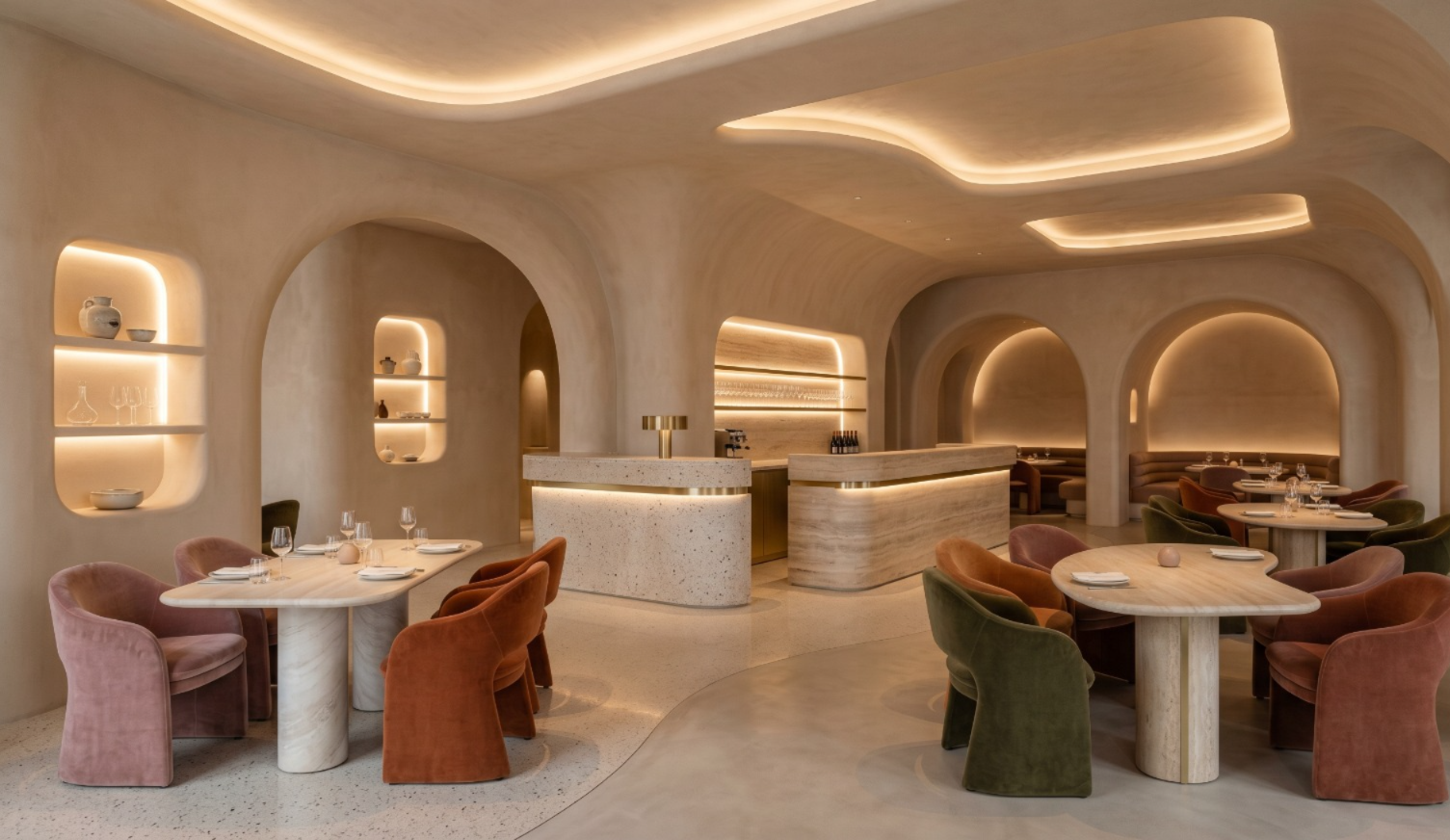 Indoor pool area with large skylight, surrounded by potted plants and modern sun loungers. The space feels serene, with trees visible outside.